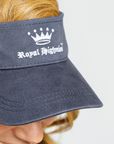 Navy blue visor with 'Royal Highness' logo worn by a person on a white background