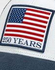Cap with American flag patch celebrating 250 years on a white and gray background