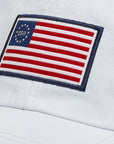 Patch of the American flag on a white hat