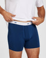 A man wearing navy blue boxer briefs with a white elastic waistband with crown logos