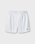 White athletic shorts with an elastic waistband and a small green crown logo on the lower left leg, shown against a light gray background.