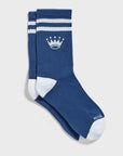 A pair of blue crew socks with white stripes on the cuff, a white crown logo, and white toe and heel sections.