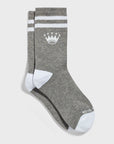 A pair of gray crew socks with white stripes near the top, a white crown logo, and white toe and heel sections.