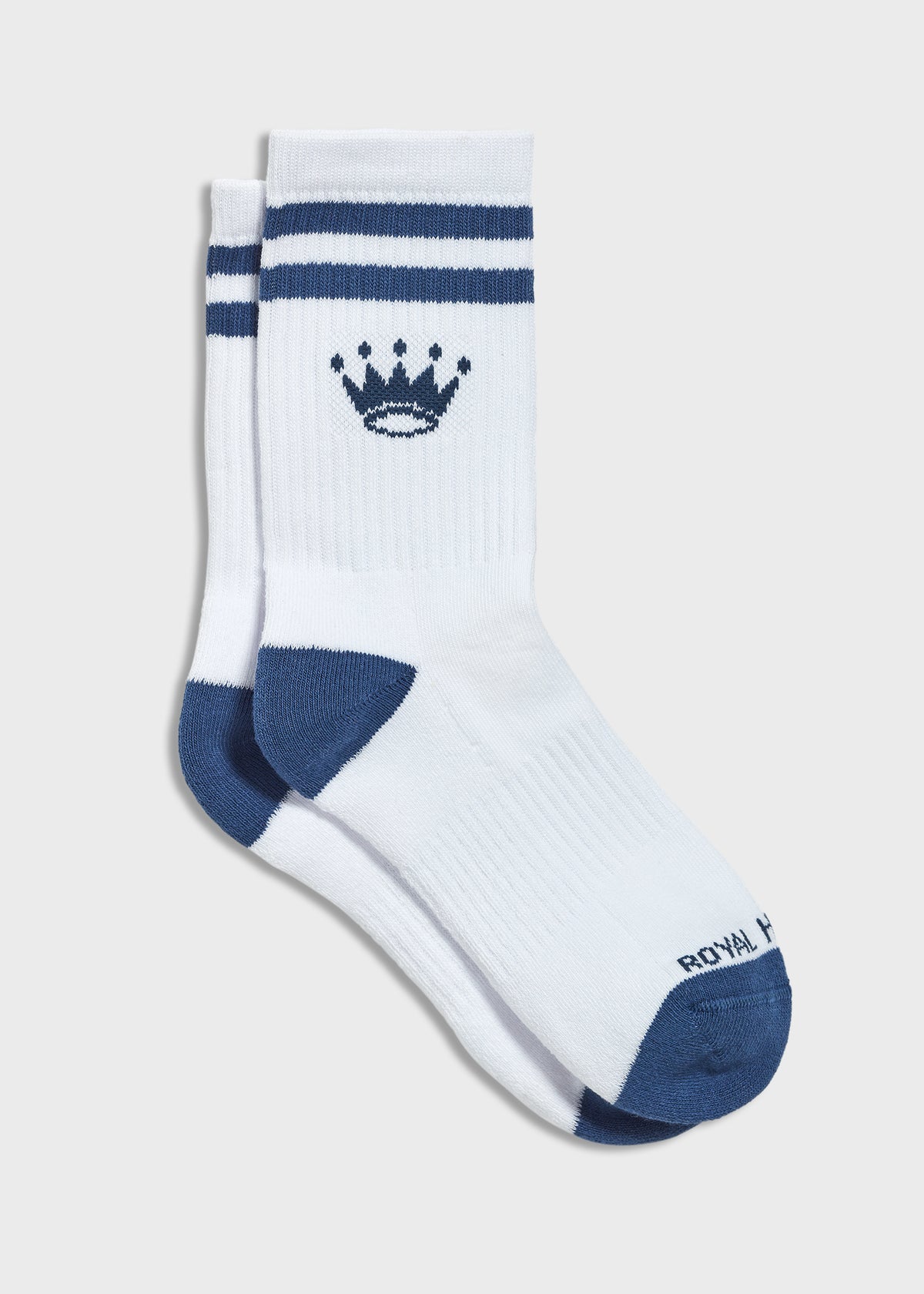 A pair of white crew socks with navy blue stripes, a crown logo, and a navy blue toe and heel, featuring the partial brand name 'ROYAL' on the foot.