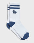 A pair of white crew socks with navy blue stripes, a crown logo, and a navy blue toe and heel, featuring the partial brand name 'ROYAL' on the foot.