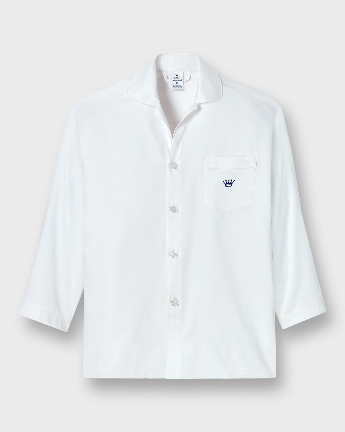 A white long-sleeve button-up shirt with a collar, a chest pocket, and a small navy blue crown logo embroidered on the pocket, displayed against a light gray background.