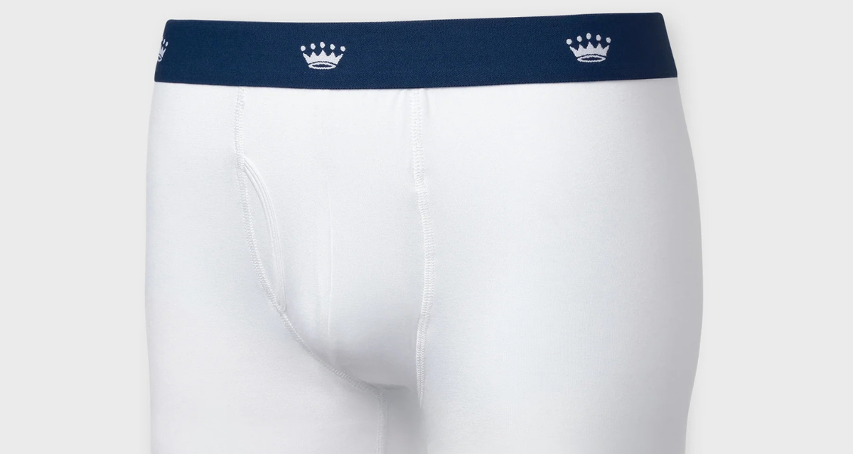 White men's boxer briefs with a navy blue waistband featuring two small white crown logos, shown on a light gray background.