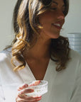 Short clip of a woman wearing white dress with a V-neckline.