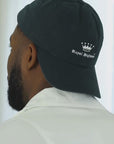 Short video clip showing a man wearing a navy Royal Highnies hat worn backwards.
