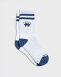 A pair of white crew socks with navy blue stripes at the cuff, a navy blue crown logo on the upper leg, and navy blue toe and heel sections. 