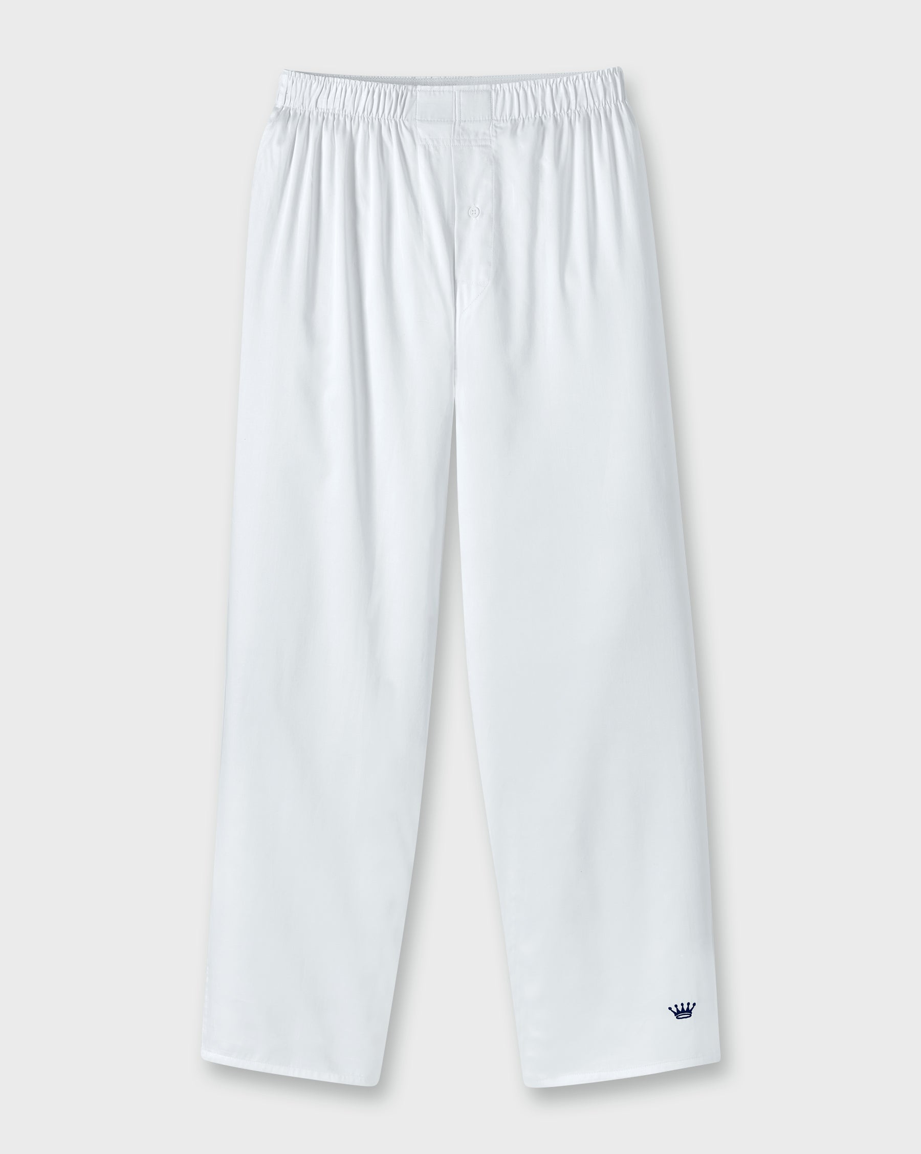 White lounge pants with an elastic waistband and a small navy embroidered crown logo near the lower left hem, shown against a light gray background.